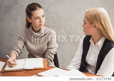 Successful attractive women friends chatting. 35173789