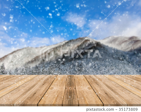 Wooden board table top blurred snowfall background Wooden board table top blurred snowfall background 35173809