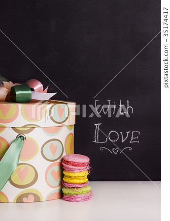 gift box and sweet macaroons on chalkboard 35174417