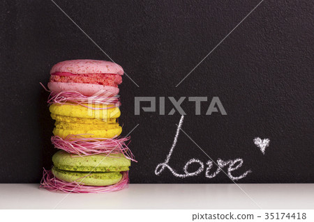 Sweet macaroons and chalkboard background Sweet macaroons and chalkboard background 35174418