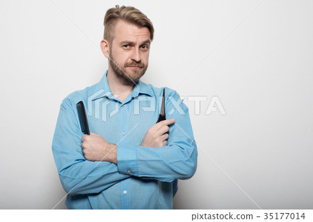 attractive male hairdresser with scissors and comb attractive male hairdresser with scissors and comb 35177014