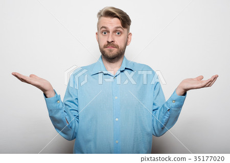 Frustrated man in shirt looking at camera  35177020