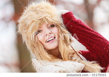 Portrait of pretty smiling woman in fur winter hat Portrait of pretty smiling woman in fur winter hat 35179301