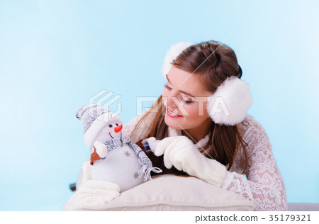 Cute woman with little snowman. Winter fashion. 35179321