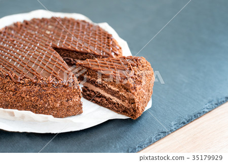 Sliced tasty chocolate cake on slate table. Stop 35179929