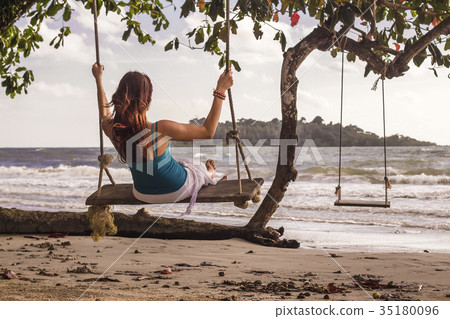 Woman on swings at the seashore Woman on swings at the seashore 35180096