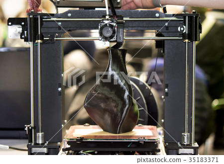 3D printer printing a model in the form of black 3D printer printing a model in the form of black 35183371