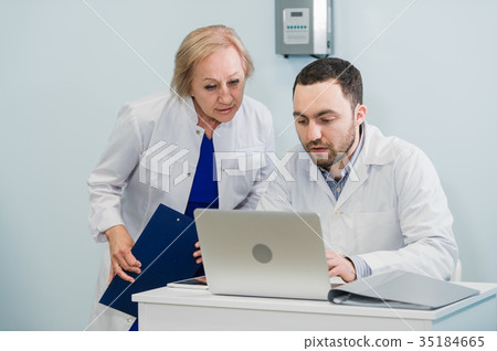 Handsome senior female doctor and handsome young Handsome senior female doctor and handsome young 35184665