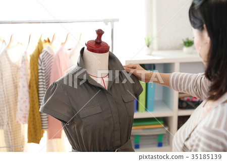 Designer checking the finished clothes 35185139
