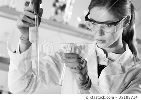 Young scientist pipetting in life science 35185714