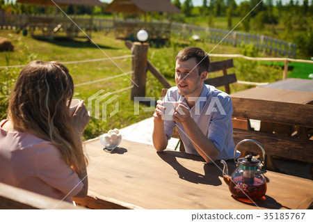 joyful couple drinking tea outdoors joyful couple drinking tea outdoors 35185767
