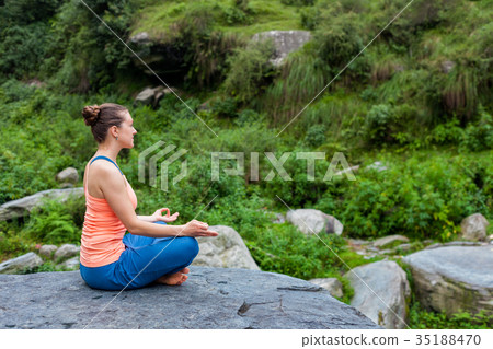 Woman in Padmasana outdoors 35188470