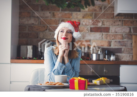 Beautiful young woman in Santa Claus hat 35190816