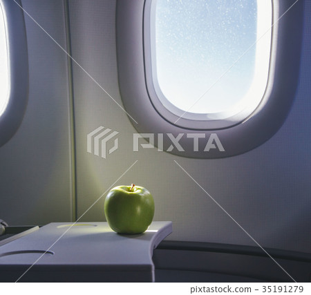 a green apple on the table of airplane a green apple on the table of airplane 35191279