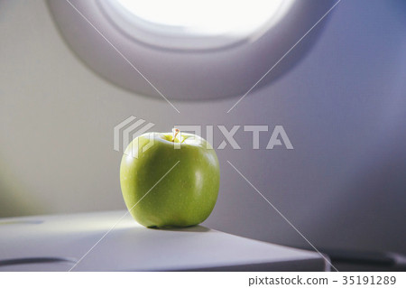 a green apple on the table of airplane a green apple on the table of airplane 35191289