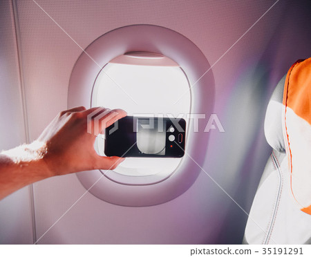 passanger makes photos on the smartphone in the passanger makes photos on the smartphone in the 35191291