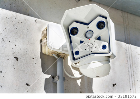 Dual lens modern security camera attached to wall 35191572