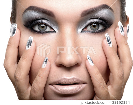 Beautiful girl with the silver makeup and nails. 35192354