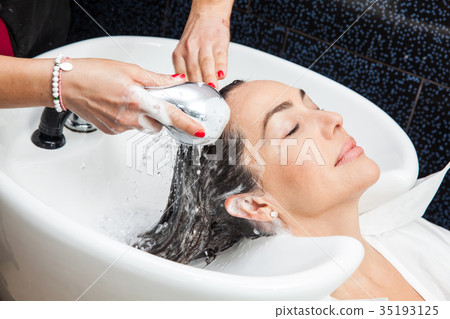White woman getting a hair wash in a beauty salon White woman getting a hair wash in a beauty salon 35193125