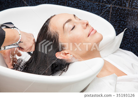 White woman getting a hair wash in a beauty salon 35193126