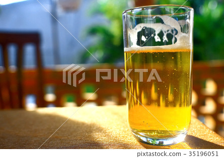 A glass of beer on a table 35196051