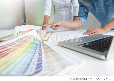 Architects engineer discussing at the table with blueprint - Clo 35197309