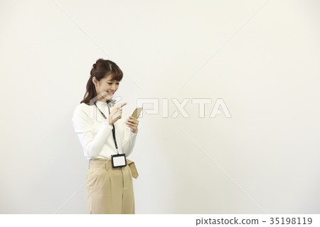 Woman operating a smartphone 35198119