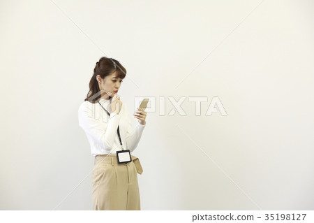 Woman operating a smartphone Woman operating a smartphone 35198127