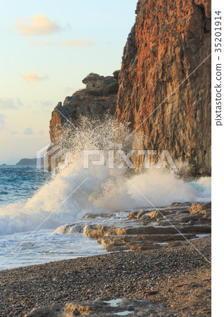 Winter sea with huge wave crushing at rocky shore Winter sea with huge wave crushing at rocky shore 35201914