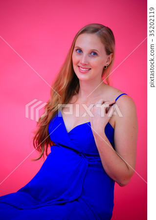 Blonde pregnant woman staring wearing a blue dress @ studio shot 35202119