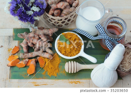 Turmeric powder with honey and milk for scrub. Turmeric powder with honey and milk for scrub. 35203650