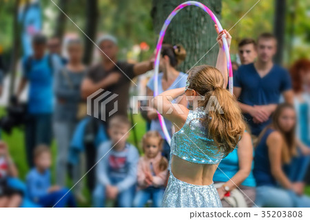 Girl in beautiful dress performs with hula hoops 35203808