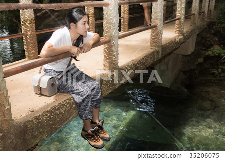 Woman walking on the path in the tropical forest Woman walking on the path in the tropical forest 35206075