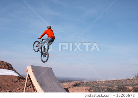 man in sportswear jumping high on mountain bike man in sportswear jumping high on mountain bike 35206678