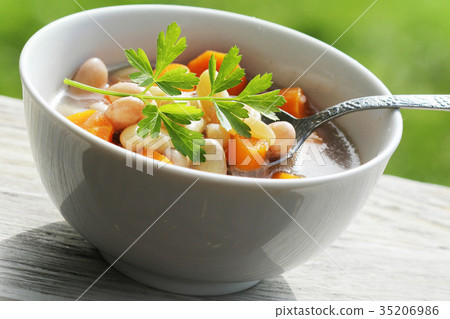 Vegetable soup with bean and carrots on green 35206986