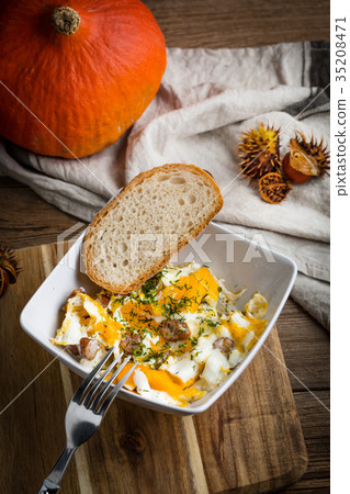 Scrambled eggs with sausage and bread. Scrambled eggs with sausage and bread. 35208471
