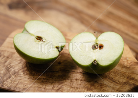 halves of green apple on wood table halves of green apple on wood table 35208635