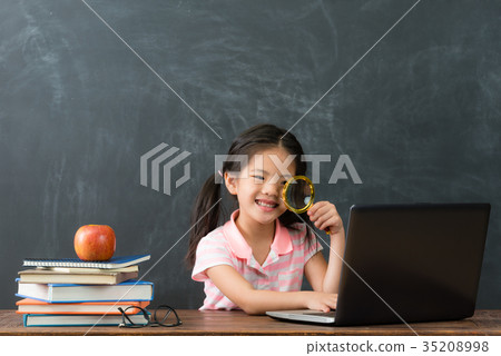 happy beautiful female kid holding magnifying 35208998