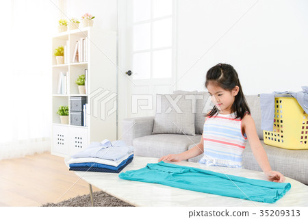 pretty female little kid children folding clothing pretty female little kid children folding clothing 35209313