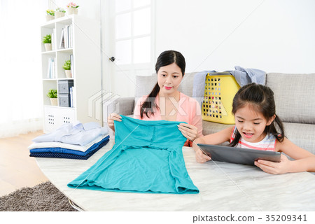 attractive young housewife folding clothing attractive young housewife folding clothing 35209341