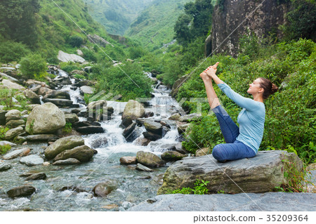 Woman doing Ashtanga Vinyasa Yoga asana outdoors 35209364