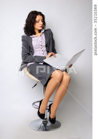 Business woman portrait. The brunette is walking Business woman portrait. The brunette is walking 35210369