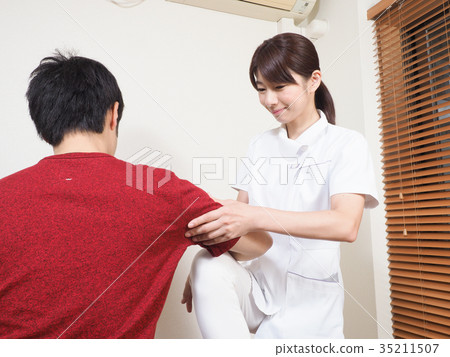 Woman massaging arms Woman massaging arms 35211507