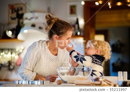 Young family making cookies at home. Young family making cookies at home. 35211997