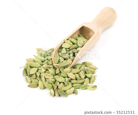 Cardamom in wooden spoon isolated on a white Cardamom in wooden spoon isolated on a white 35212531