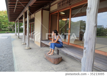 Young woman sitting on the curb 35213095