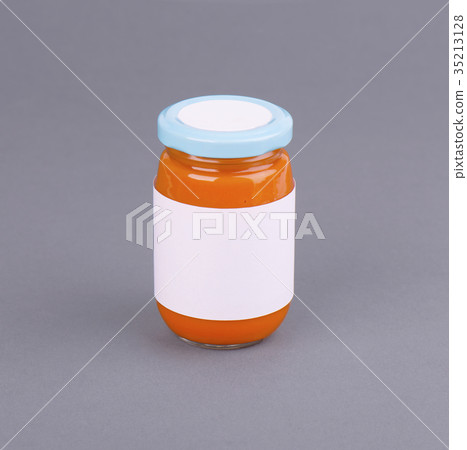 Orange glass jar for baby food bank on grey Orange glass jar for baby food bank on grey 35213128