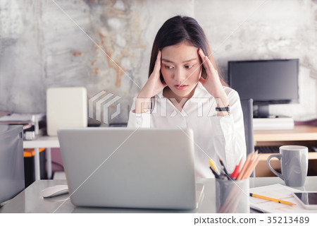 Young business people are suffering from headaches Young business people are suffering from headaches 35213489