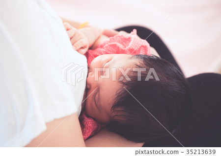 Mother breastfeeding her newborn baby girl Mother breastfeeding her newborn baby girl 35213639