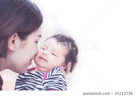 mother hugging and kissing her newborn baby girl 35213736